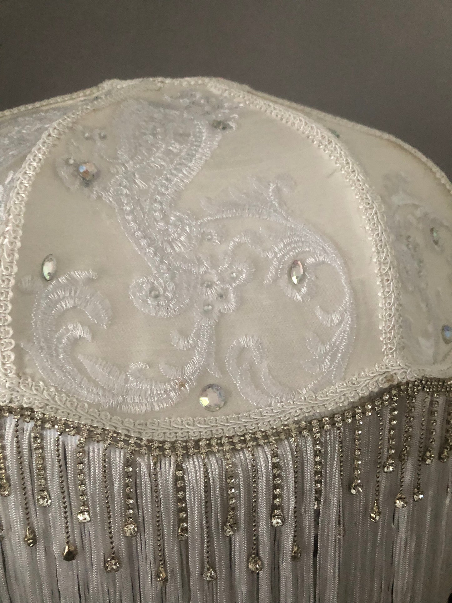 Close-up of fabric texture 2 diamantes – “Smooth white silk with lace overlay and diamante accents on a Victorian-style lampshade – antique-inspired handmade lighting.”