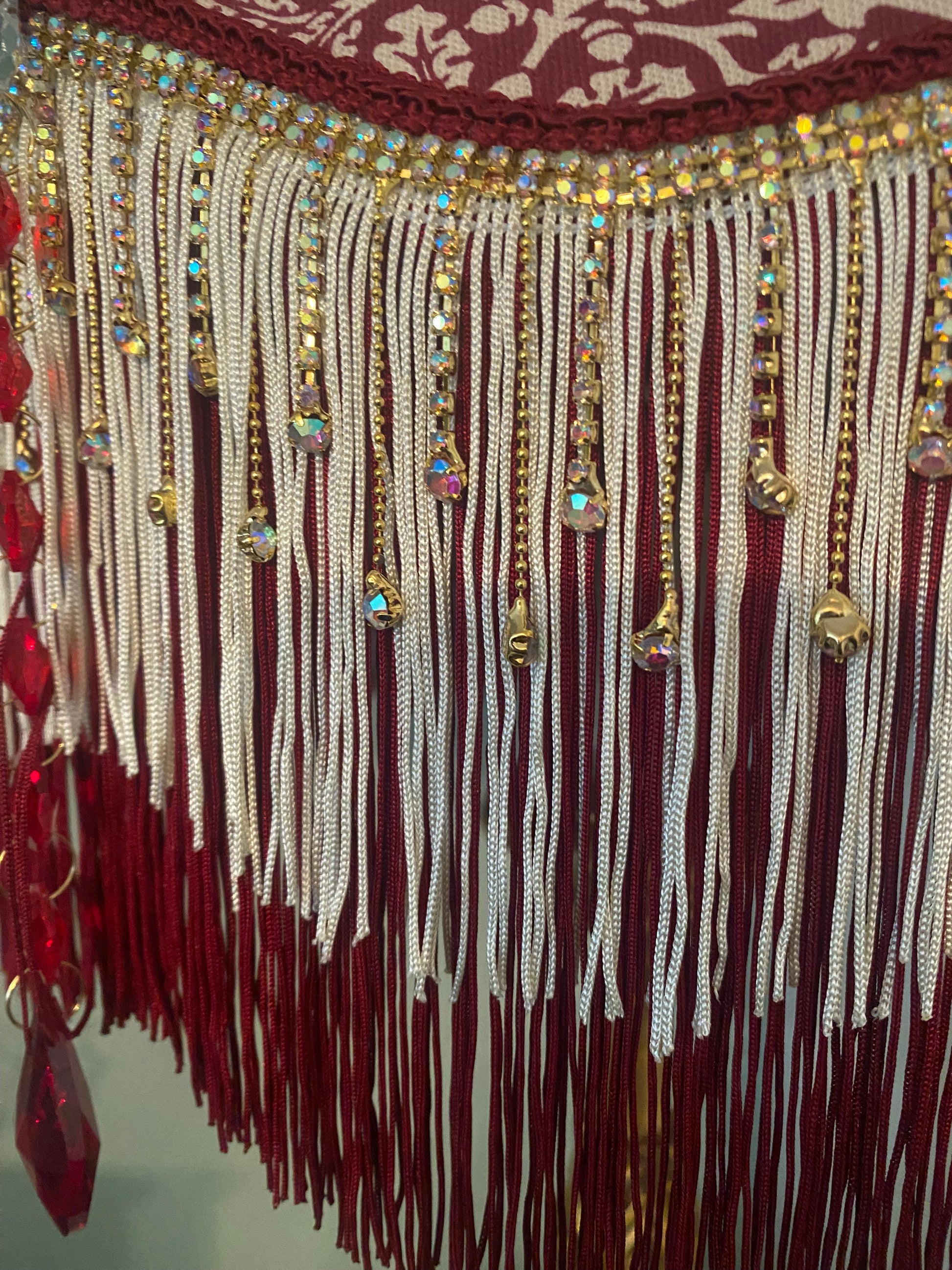 Close-up of fringe and trim – “Gold diamante fringe with burgundy edging on a William Morris Victorian lampshade – handcrafted vintage lighting detail.”