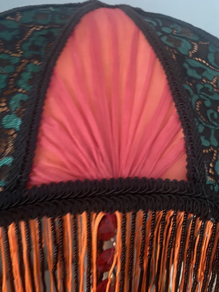 3. Detail view of the hand-pleated red chiffon sections, highlighting the soft texture and craftsmanship against the structured lace overlay