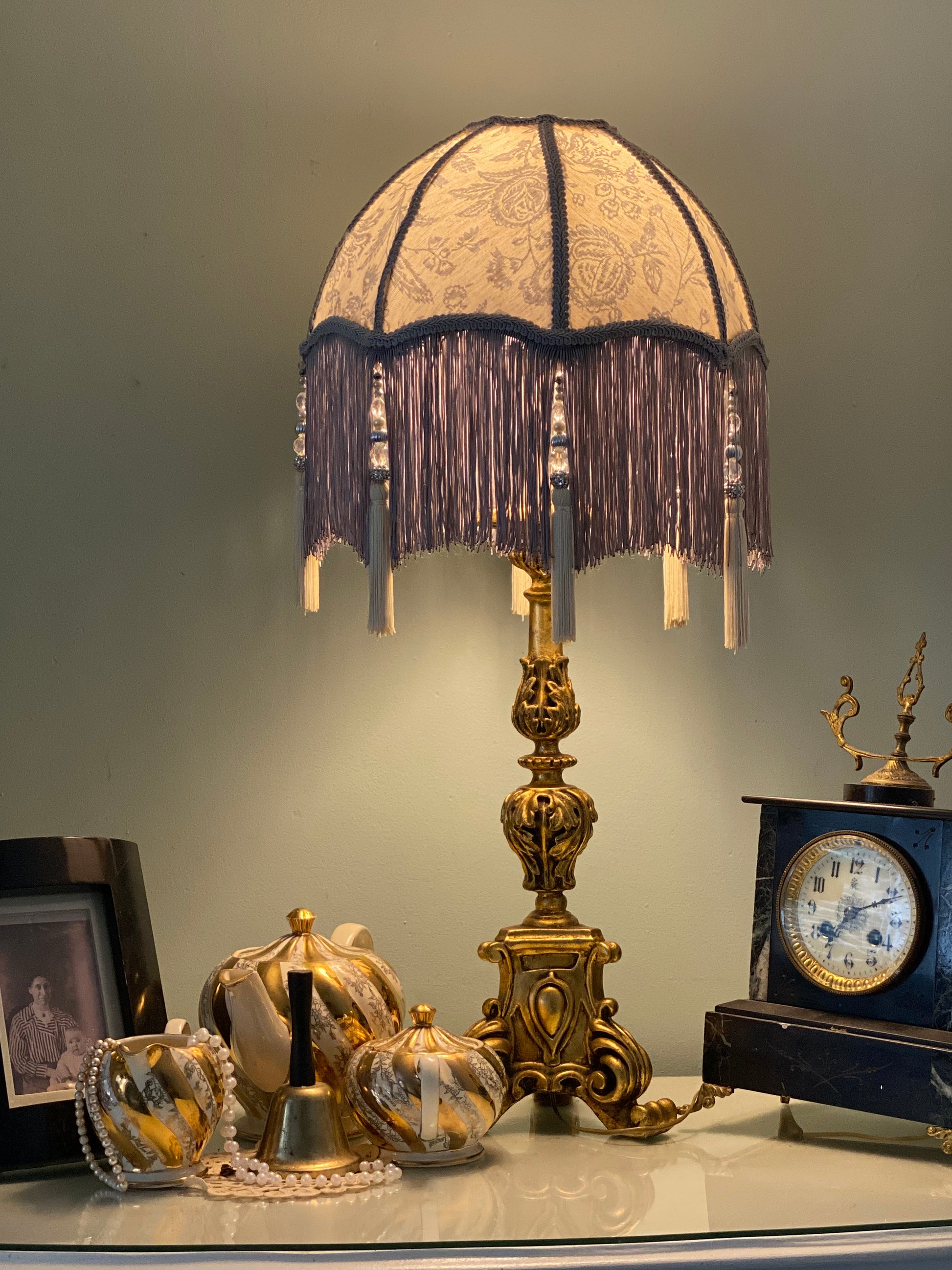 .	Full lampshade view – A grey Victorian parachute-style lampshade in blue toile fabric, with a soft scalloped shape and a long beaded fringe.